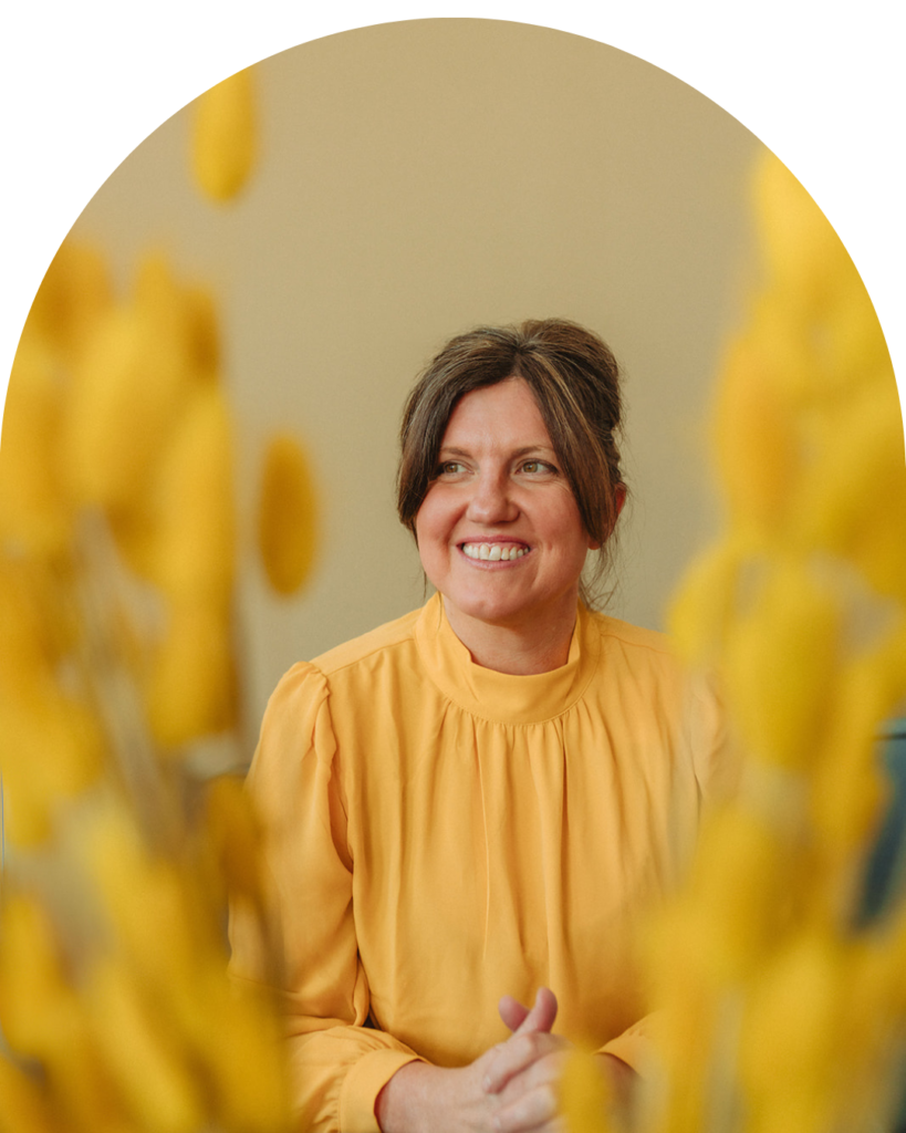 Dr. Jessica Thomas, a grief therapist, in a yellow top